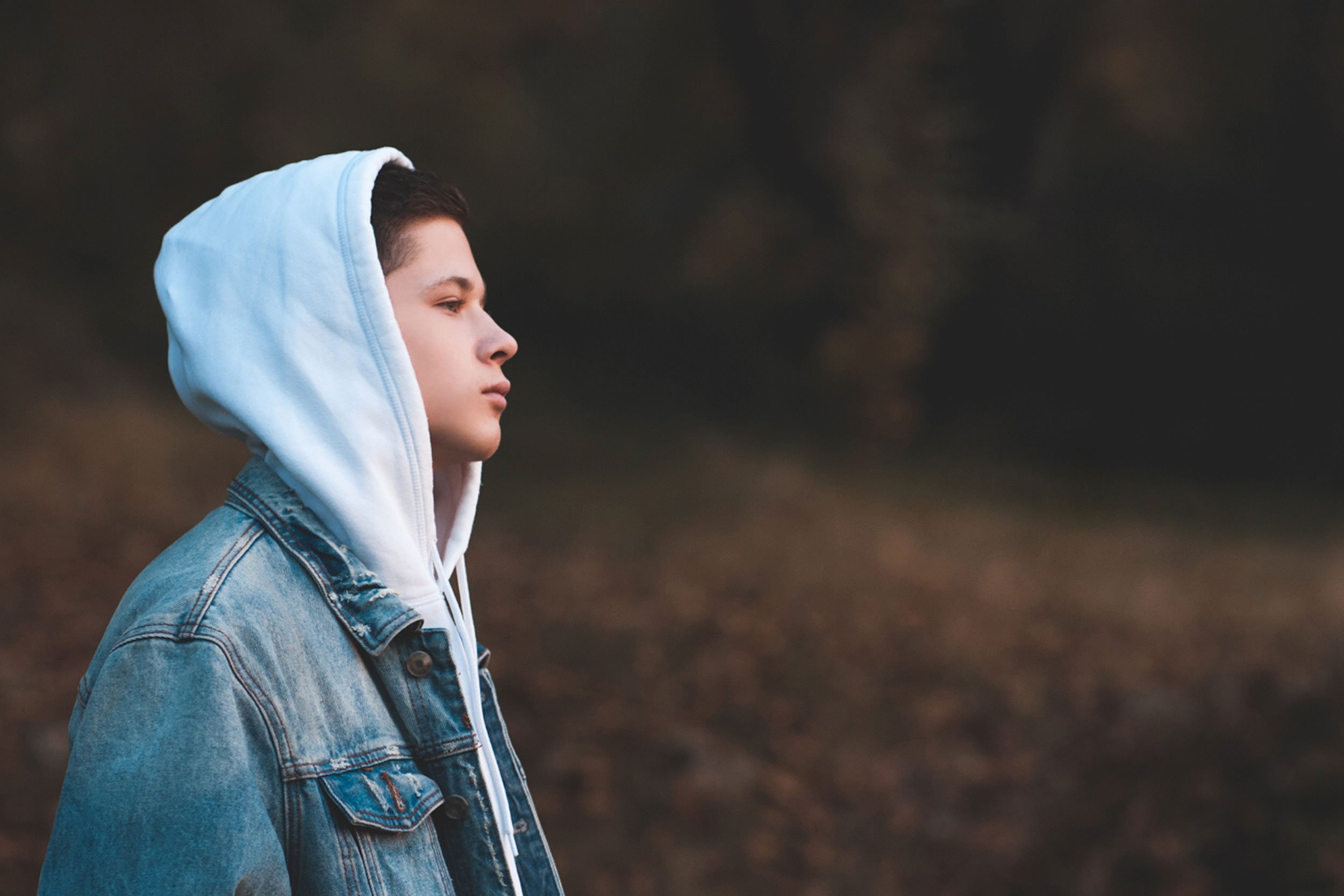 Boy with hoodie on head looking into the distance