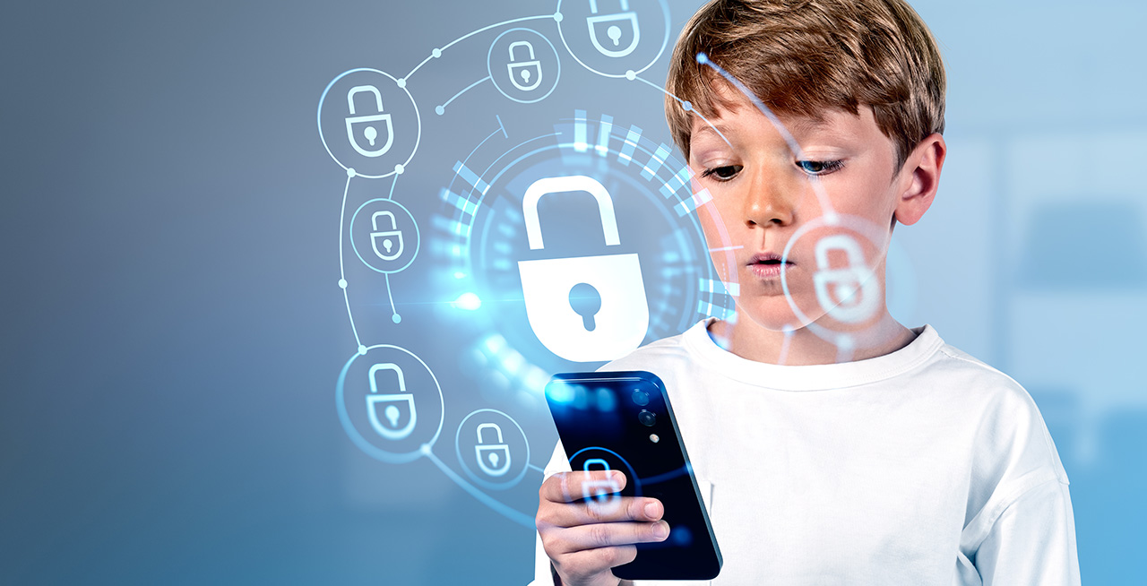 Young male student looking at phone that has a ring of locked icons surrounding it.
