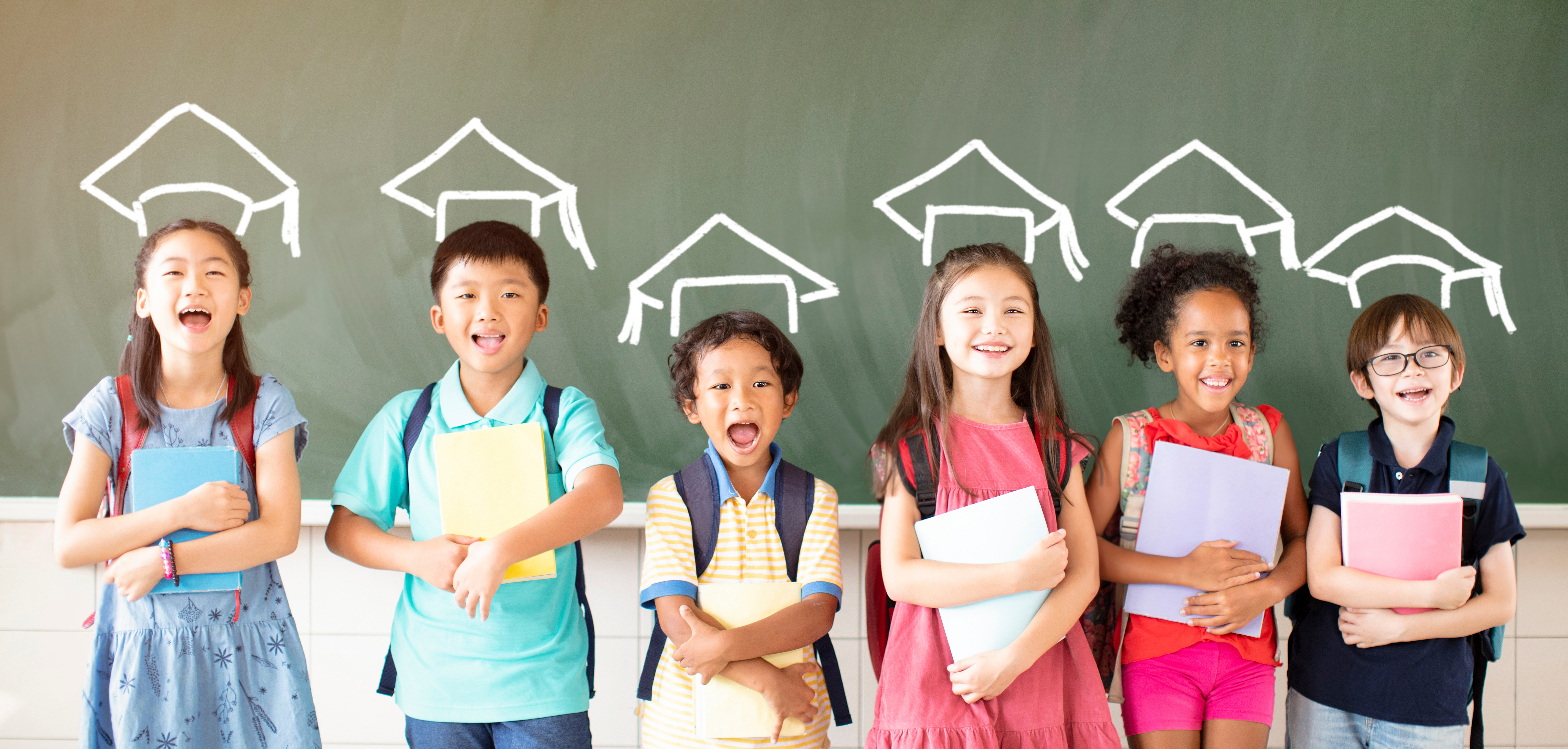 kids standing by a blackboard