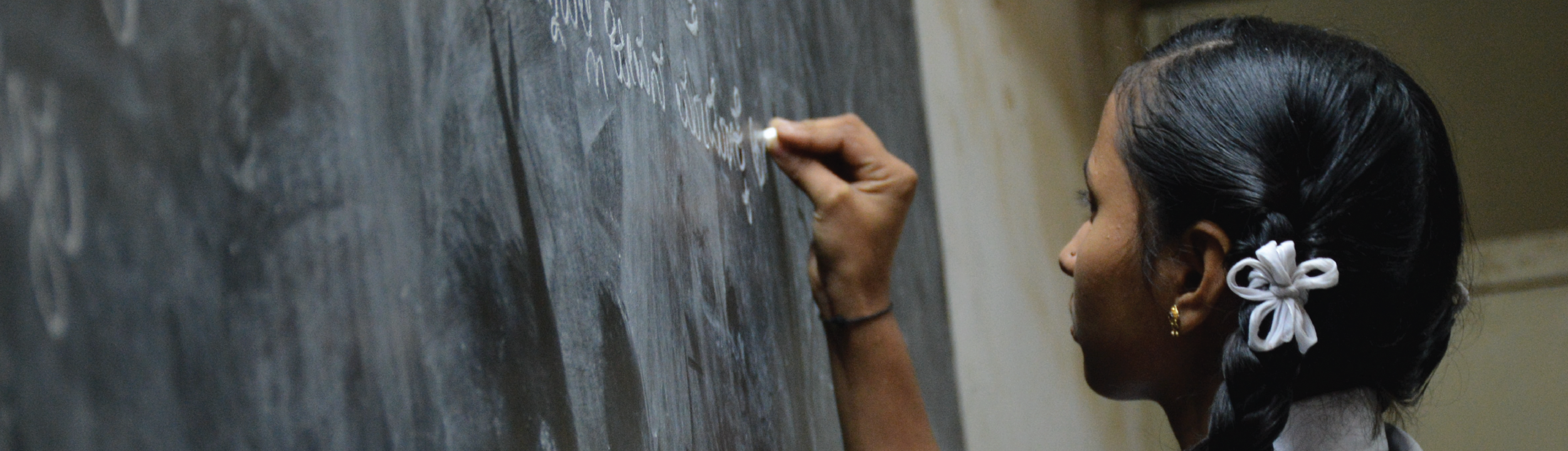 Student writing on chalkboard