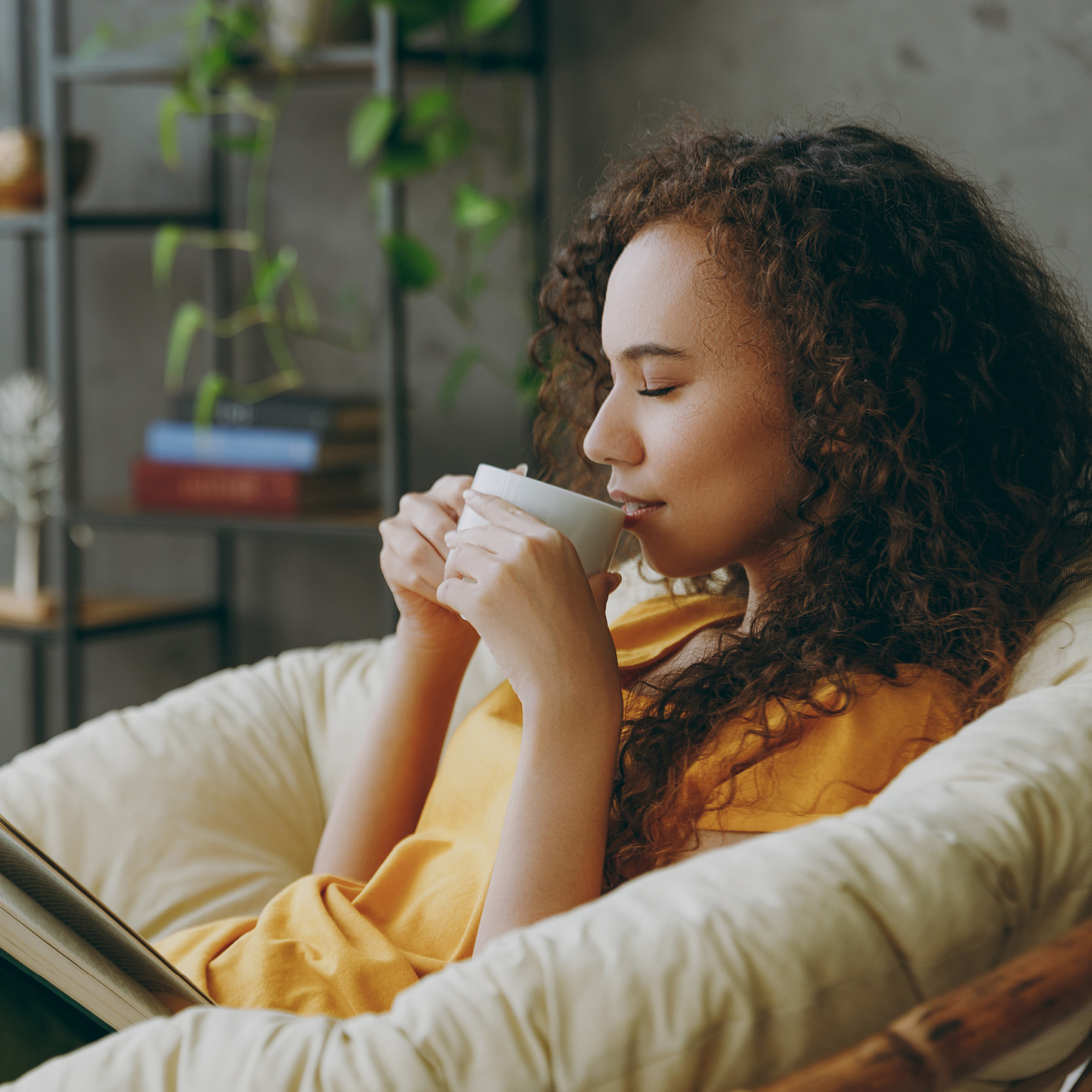 Teacher relaxing by enjoying a cup of coffee and reading a book.