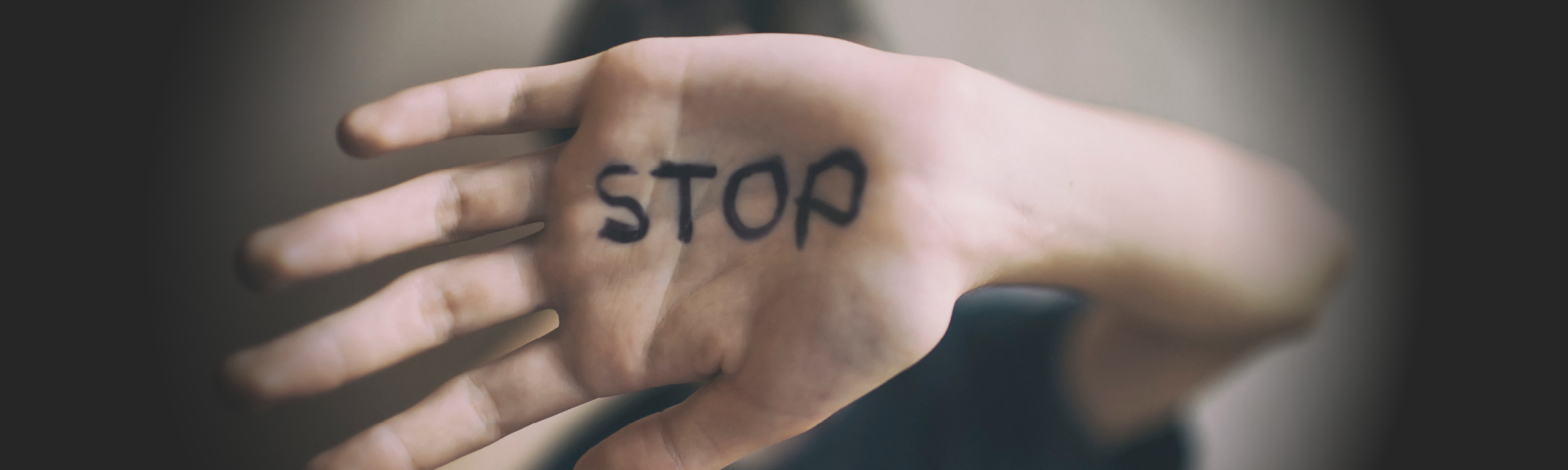 Child's hand with STOP written on palm