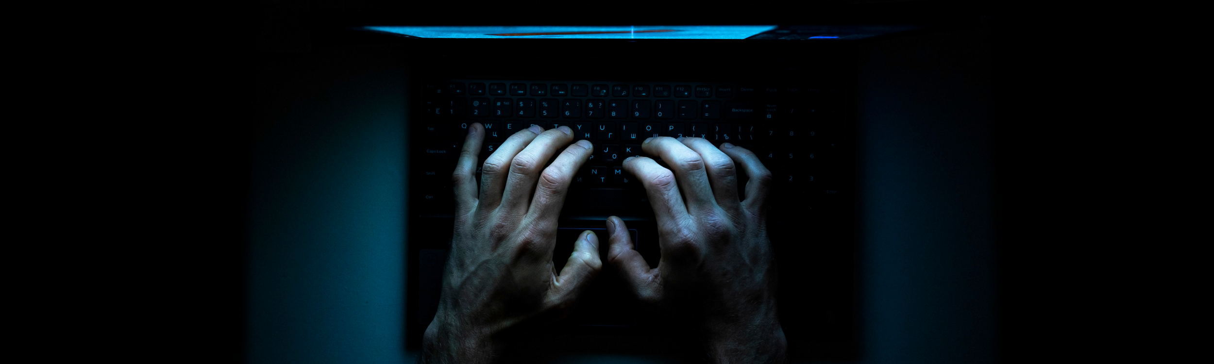 Hands typing on a laptop