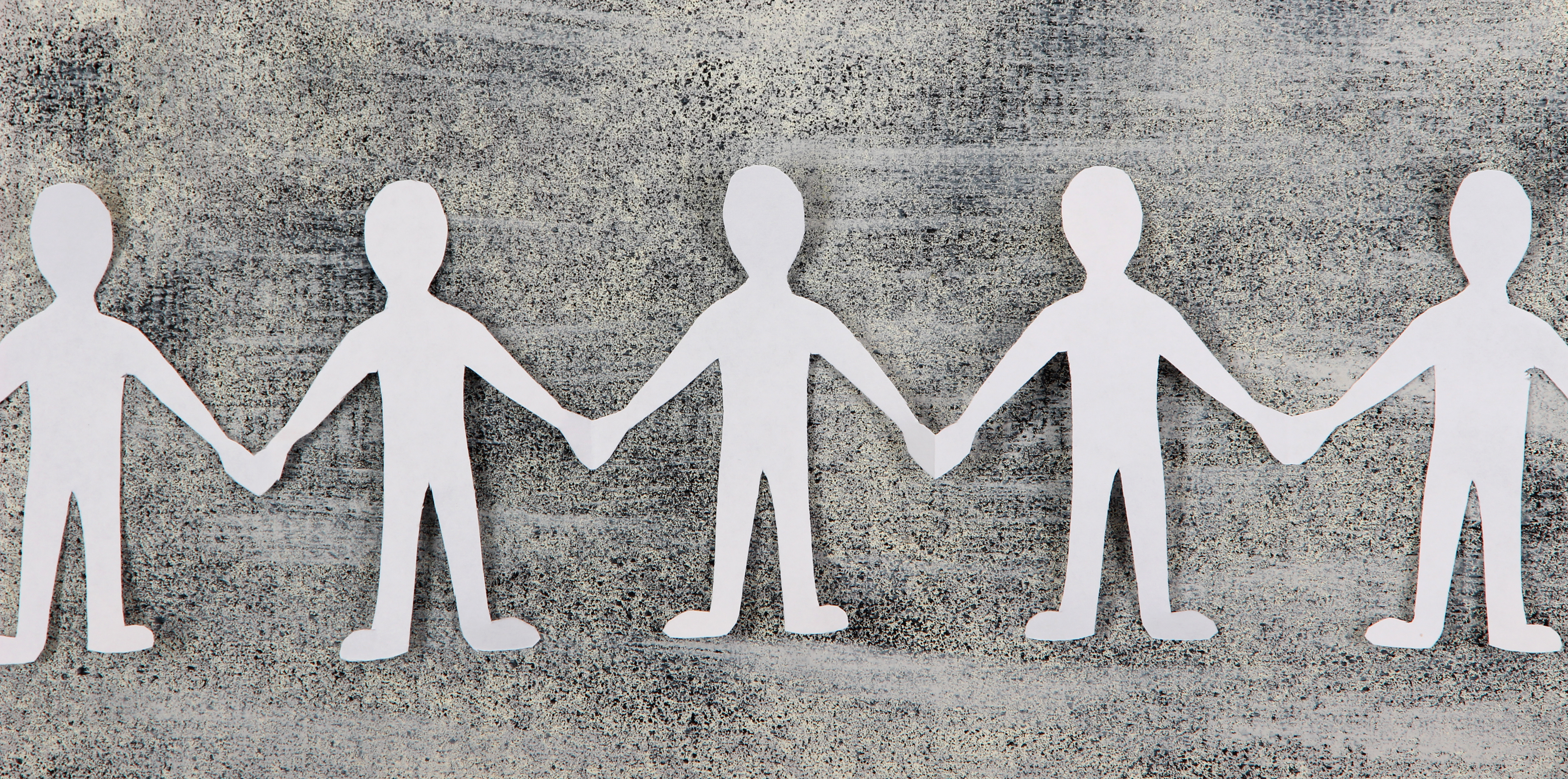 Paper cutout people holding hands