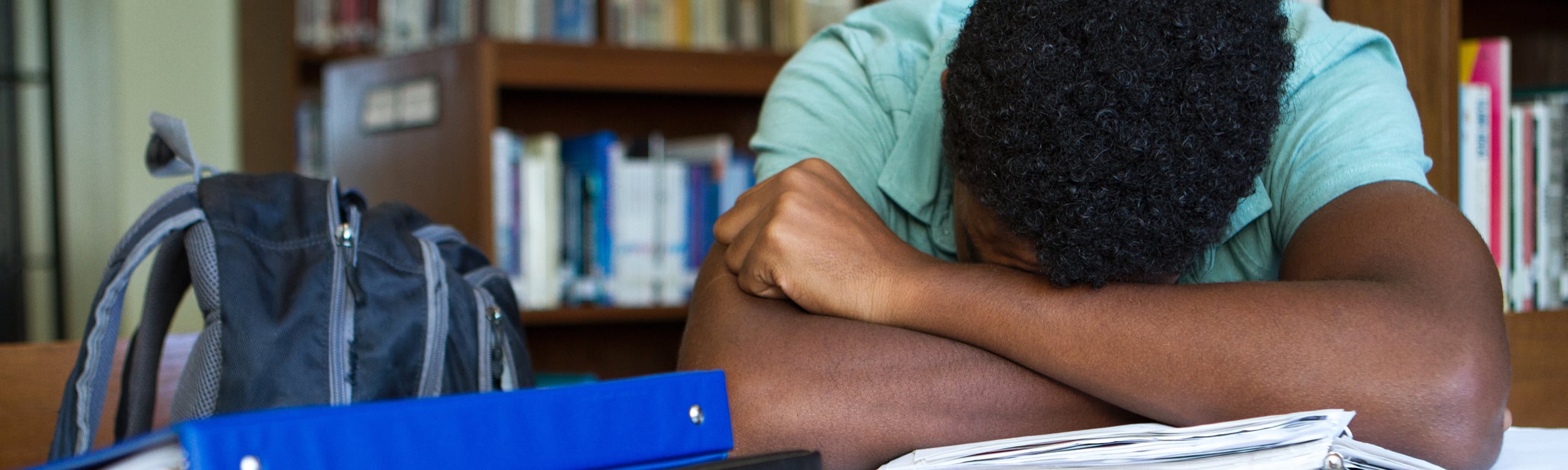 Student in head with crossed arms