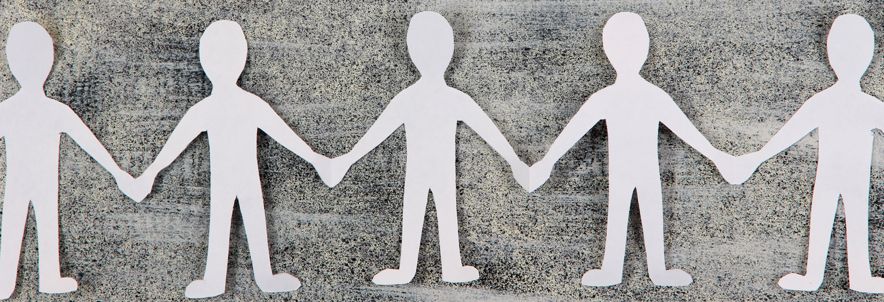 Paper cutout people holding hands